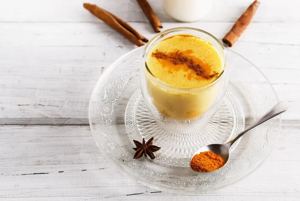 Turmeric Golden Link Latte in a glass with cinnamon and star anise